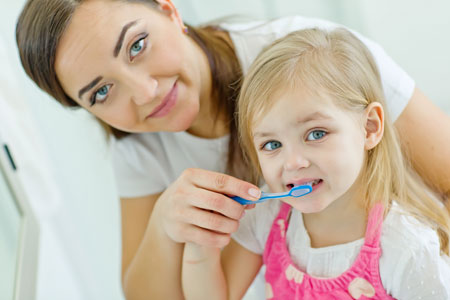 Mom and Daughter brushing their teeth - Pediatric Dentist in Janesville, WI